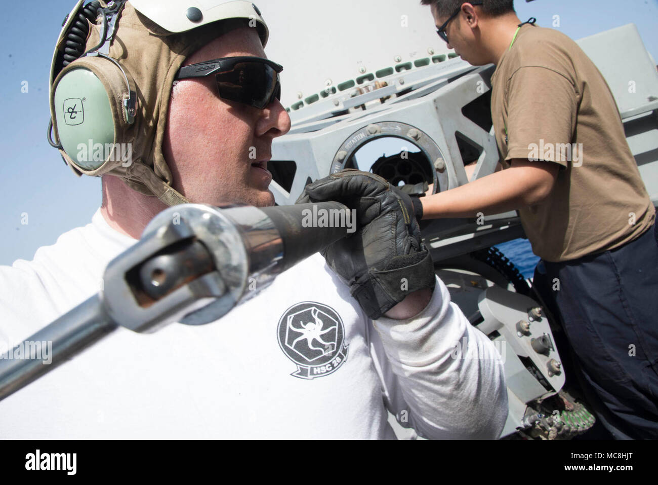 U.S. 5TH FLEET AREA OF OPERATIONS (March 26, 2018) Aviation Machinist Mate 1st Class Aaron Williams and Fire Controlman 2nd Class Michael Floresca remove a barrel from a close-in weapons system (CIWS) aboard the Wasp-class amphibious assault ship USS Iwo Jima (LHD 7), March 26, 2018. Iwo Jima, homeported in Mayport, Fla., is on a regularly scheduled deployment to the U.S. 5th Fleet area of operations in support of maritime security operations to reassure allies and partners, and preserve the freedom of navigation and the free flow of commerce in the region. Stock Photo