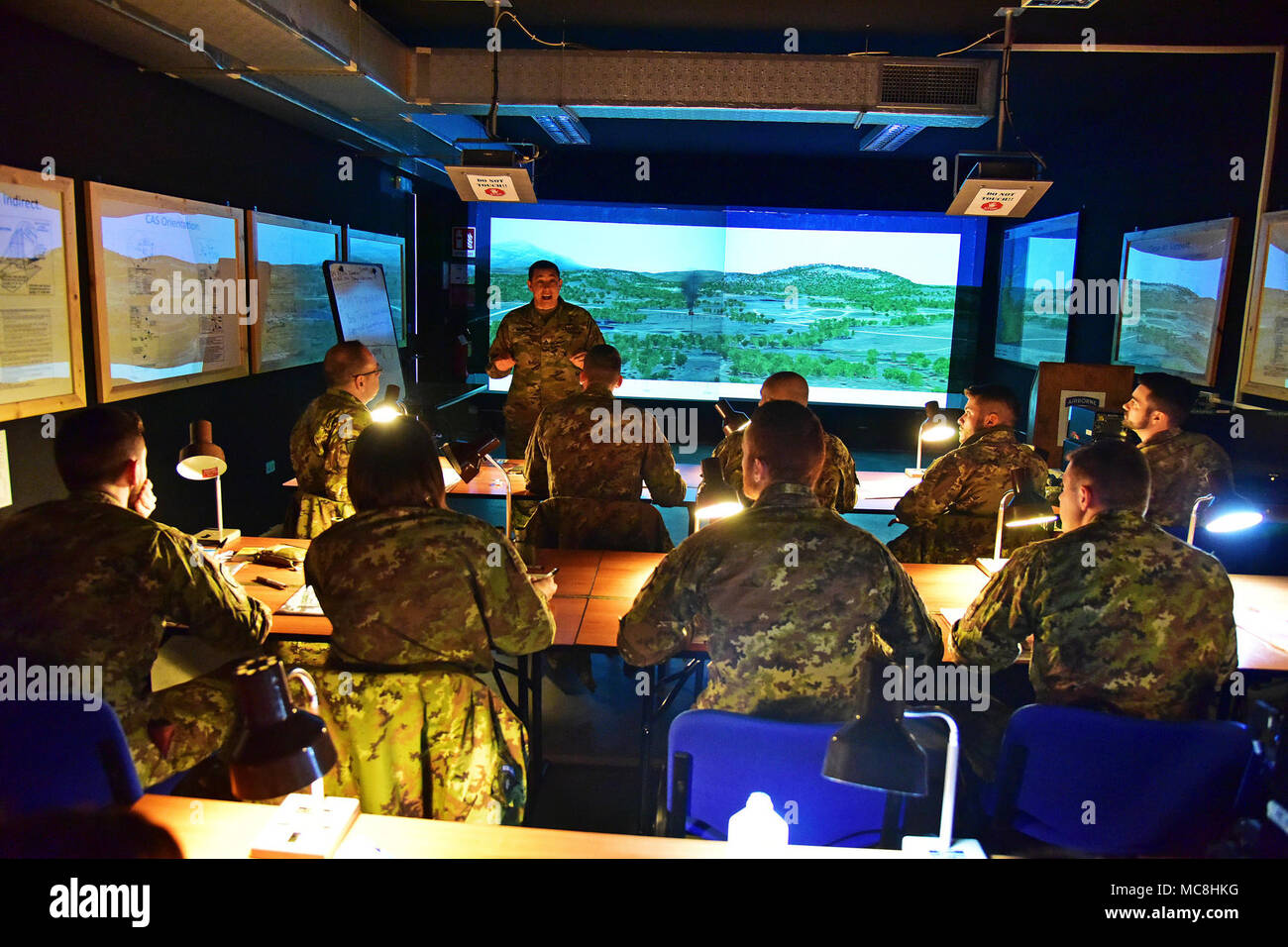 U.S. Army Staff Sgt. Change L. McGraw, a Paratrooper assigned to the 173rd Airborne Brigade instructs Italian Army Paratroopers assigned to Regiment “Savoia Cavalleria” Folgore Brigade Grosseto, during training using Call For Fire Trainer system (CFFT) at Caserma Ederle Vicenza, Italy, March 27, 2018. Italian Paratroopers use U.S. Army RTSD South equipment to enhance bilateral relations and to expand levels of cooperation and the capacity of the personnel involved in joint operations. Stock Photo