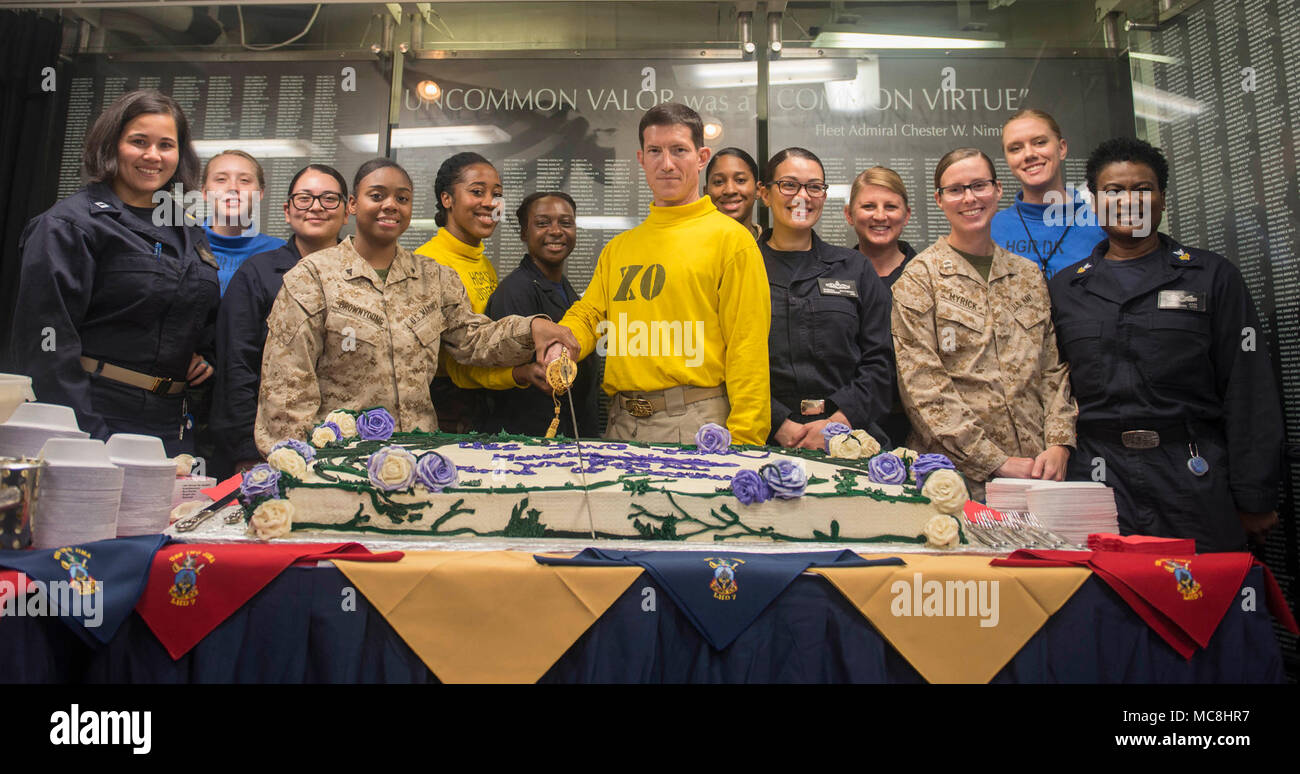 5TH FLEET AREA OF OPERATIONS (March 28, 2018) Capt. Darrell Canady, executive officer of the Wasp-class amphibious assault ship USS Iwo Jima,  and members of the multicultural heritage committee cut a cake during a Women's History Month celebration on the ship’s mess decks, March 28, 2018. Iwo Jima, homeported in Mayport, Florida, is on a regularly scheduled deployment to the U.S. 5th Fleet area of operations in support of maritime security operations to reassure allies and partners, and preserve the freedom of navigation and the free flow of commerce in the region. Stock Photo