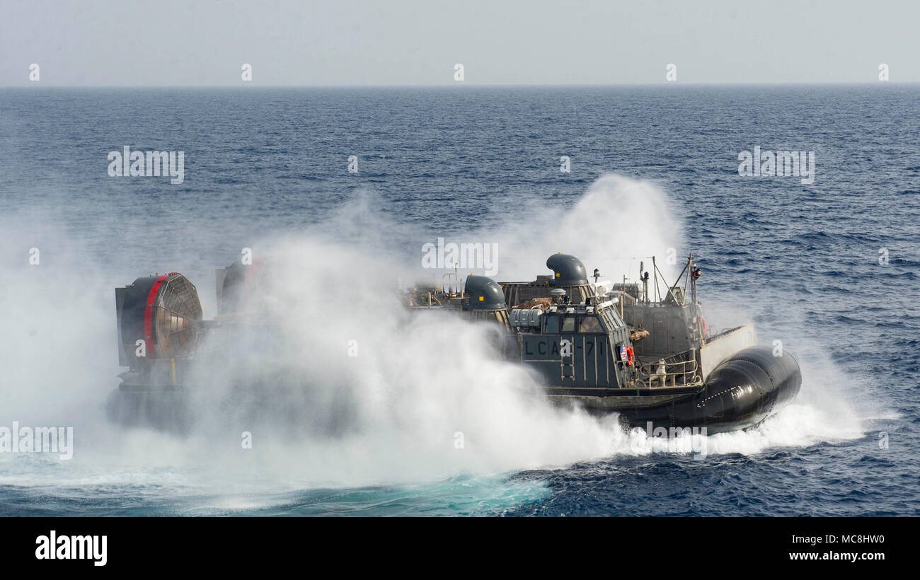 5TH FLEET AREA OF OPERATIONS (March 29, 2018) A landing craft, air cushion (LCAC) departs the well deck of the Wasp-class amphibious assault ship USS Iwo Jima (LHD 7), March 29, 2018. Iwo Jima, homeported in Mayport, Florida, is on a regularly scheduled deployment to the U.S. 5th Fleet area of operations in support of maritime security operations to reassure allies and partners, and preserve the freedom of navigation and the free flow of commerce in the region. Stock Photo