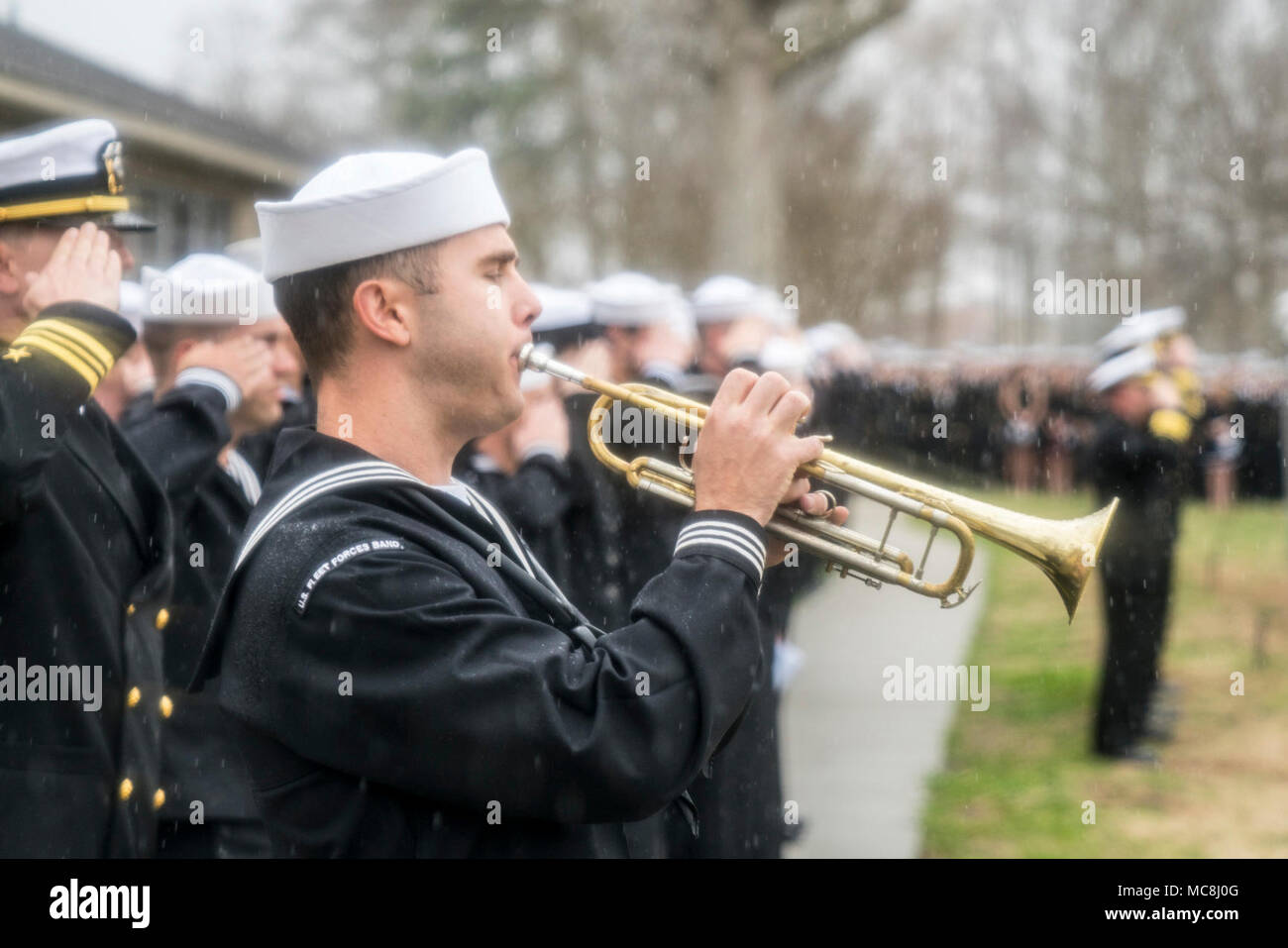 VIRGINIA BEACH, Va. (March 30, 2018) A Sailor assigned to the U.S. Fleet Forces band plays Taps as friends, family and squadron mates from the 'Blacklions' of Strike Fighter Squadron (VFA) 213 and Helicopter Sea Combat Squadron (HSC) 26 attend a memorial service for Lt. Cmdr. James Brice Johnson and Lt. Caleb King. Johnson and King lost their lives in an F/A-18F Super Hornet mishap that occured just outside Naval Air Station Key West on March 14, 2018. Stock Photo
