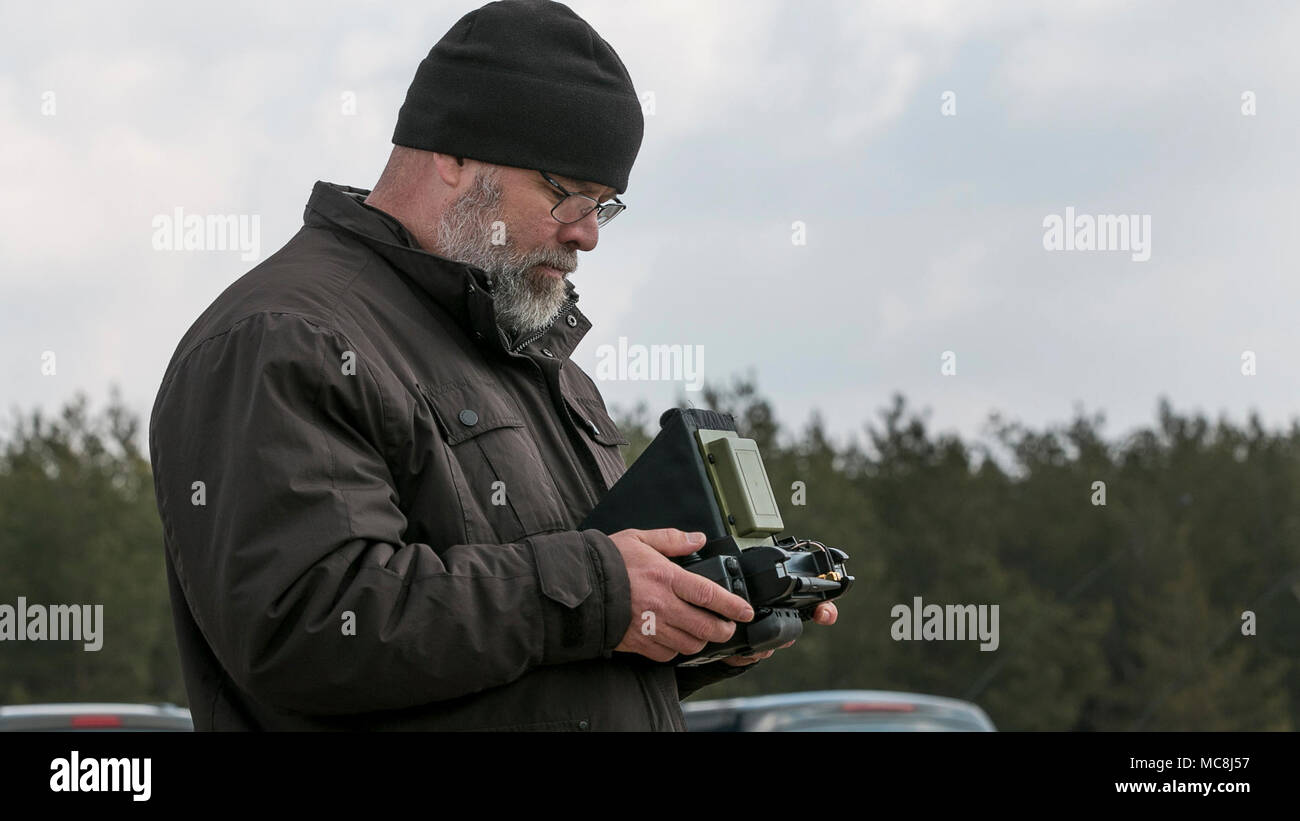 Byron Russell, an operator for an unmanned aerial system called the Instant Eye, operates the system using a remote control during a multinational joint equipment training brief on April 2, 2018 in Grafenwoehr, Germany.  The Instant Eye was demonstrated prior to a scheduled Robotic Complex Breach Concept demonstration. The Robotic Complex Breach Concept includes the employment of Robotic and Autonomous Systems (RAS) in intelligence, suppression, obscuration, and reduction. Stock Photo