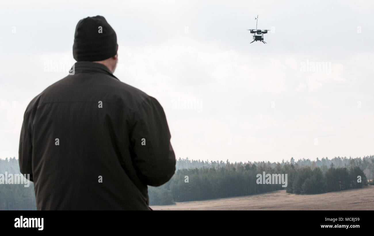 Byron Russell, an operator for an unmanned aerial system called the Instant Eye, flies the system and demonstrates its capability during a multinational joint equipment training brief April 2, 2018 in Grafenwoehr, Germany.  The Instant Eye was demonstrated prior to a scheduled Robotic Complex Breach Concept demonstration. The Robotic Complex Breach Concept (RCBC) includes the employment of Robotic and Autonomous Systems (RAS) in intelligence, suppression, obscuration, and reduction. Stock Photo