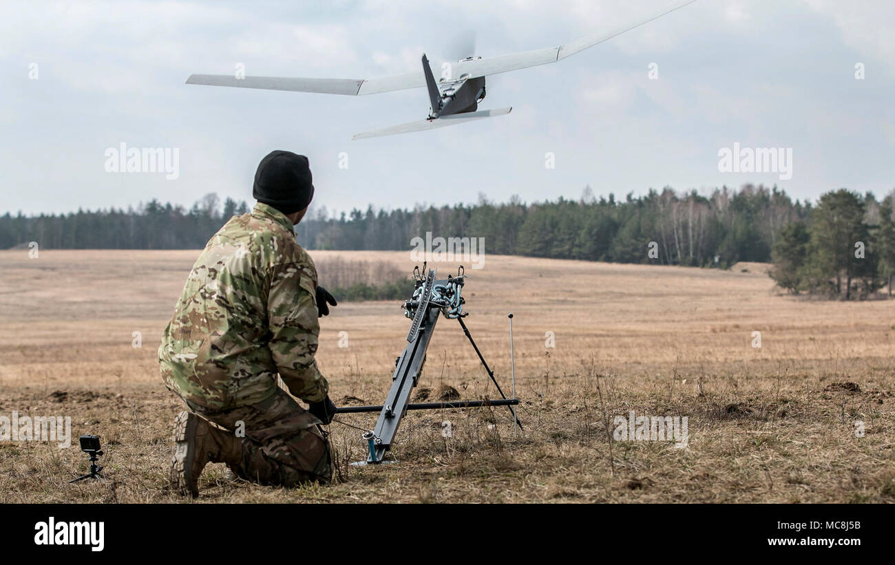 U.S. Army Pvt. Jonathan Jackson, a cannon crew member assigned to the 82nd Brigade Engineer Battalion, 2nd Brigade, 1st Infantry Division, Fort Riley, Kansas, launches a Puma aviation system during a multinational joint equipment training brief April 2, 2018, in Grafenwoehr, Germany. The Puma was demonstrated prior to a scheduled Robotic Complex Breach Concept demonstration. The Robotic Complex Breach Concept includes the employment of Robotic and Autonomous Systems (RAS) in intelligence, suppression, obscuration, and reduction. Stock Photo