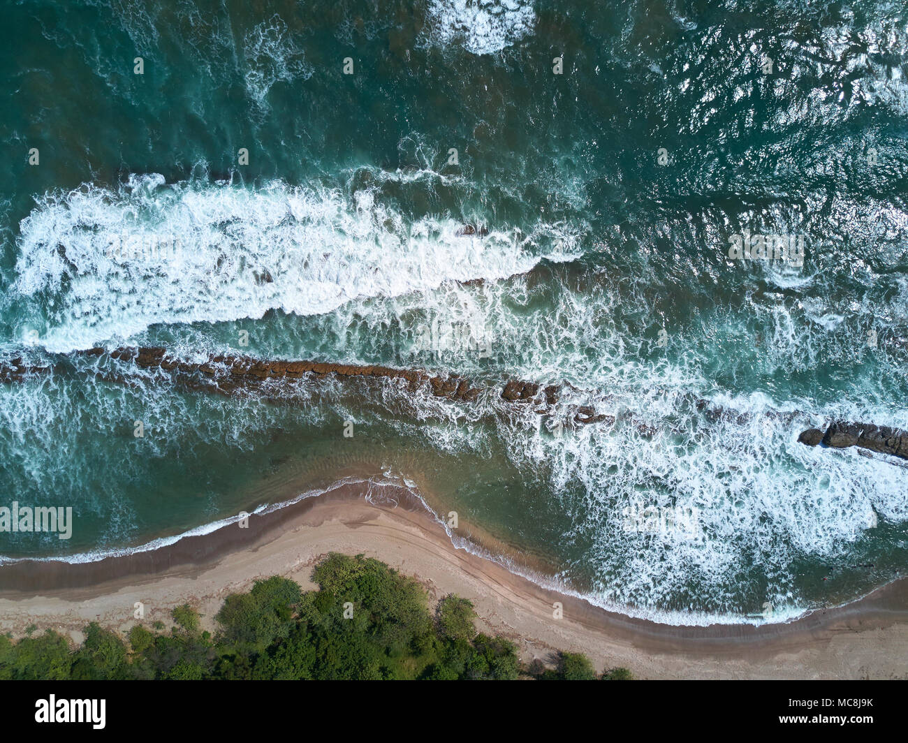 Big ocean waves hits shore aerial above view Stock Photo