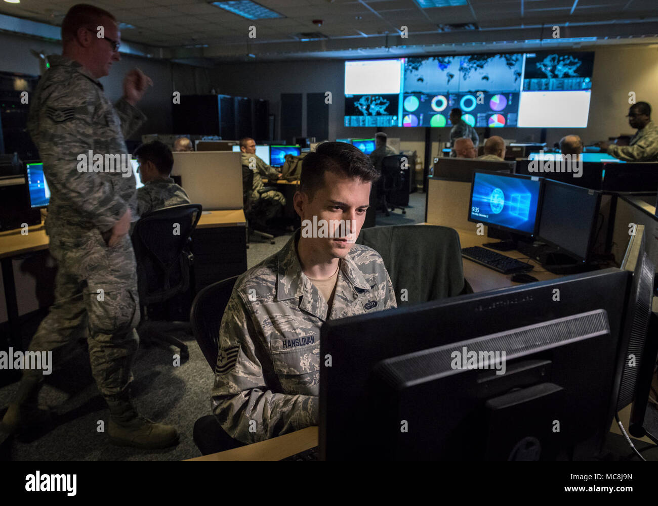 Tech. Sgt. Kyle Hanslovan, a cyber-warfare specialist serving with the 175th Cyberspace Operations Group of the Maryland Air National Guard, works in the Hunter's Den at Warfield Air National Guard Base, Middle River, Md., Dec. 2, 2017. Hanslovan served on active duty with the Air Force for six years and then worked, in civilian life, as a cyber-security contractor for the Department of Defense and now as the CEO of a cyber-security startup firm. His continuing desire to serve his country led him to the Air National Guard, where he believes his civilian experience in defensive cyber-security g Stock Photo