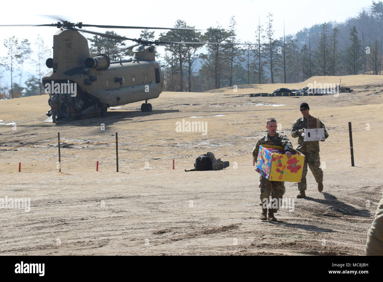 Soldiers offload boxes of Girl Scout cookies to Combined Task Force Defender in Seongju, South Korea, donated by the Osan Girl Scouts of Osan Air Base, South Korea, March 13, 2018.     The Osan Girl Scouts collected and donated nearly 200 boxes of cookies to the remote location as part of project of brining cookies to those that may not have access otherwise. Stock Photo