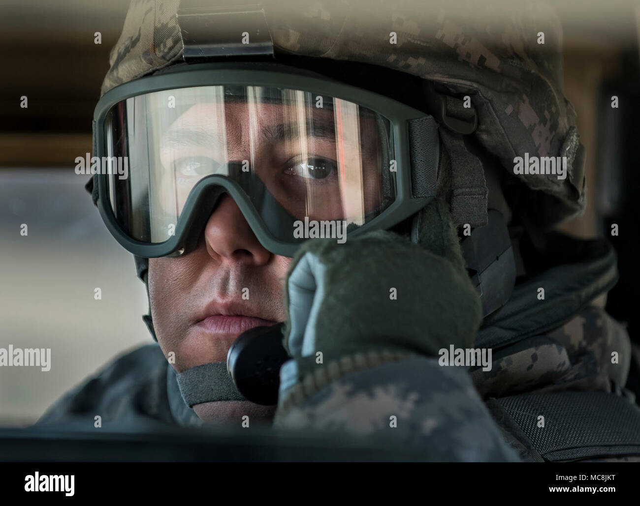 Spc. Arley Gonzalez, a U.S. Army Reserve Soldier with the 387th Transportation Detachment, out of Tampa, Florida, prepares for a range during Operation Cold Steel at Fort McCoy, Wisconsin, March 26, 2018. This iteration of Cold Steel is called Task Force Triad, a mounted gunnery training exercise in which Soldiers work as truck teams to quailfy on live-fire driving lanes. Task Force Triad runs from February to May. Each team who trains here completes a 14-day cycle that includes primary marksmanship training, a gunner skill test, digital simulated gunnery, ground qualification and finally endi Stock Photo