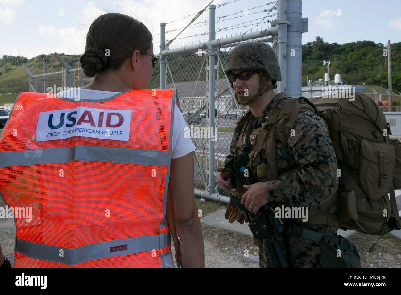 Maj. Joseph Montedoro, the executive officer of Combat Logistics Battalion 31, talks to a USAID representative role player during Amphibious Integration Training at White Beach Naval Facility, Okinawa, Japan, March 27, 2018. CLB-31, the Logistics Combat Element of the 31st Marine Expeditionary Unit, provides combat support such as supplies, maintenance, and transportation. The HAST surveys areas that have been struck by natural disasters to determine how the 31st MEU can best lend its support. The 31st MEU and Amphibious Squadron 11 conduct AIT in preparation for Certification Exercise and to  Stock Photo