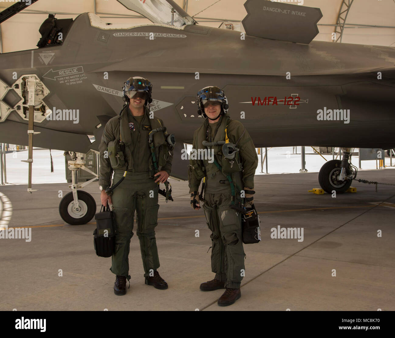 The Commanding Officer of Marine Fighter Attack Squadron 122 (VMFA-122), Lt. Col. John P. Price, and Maintenance Officer of VMFA-122, Maj. Christopher J. Kelly pose for a photo after conducting VMFA-122's first flight operations in an F-35B Lightning ll at Marine Corps Air Station (MCAS) Yuma, Ariz., March 29, 2018. VMFA-122 conducted the flight operations for the first time as an F-35 squadron. Stock Photo