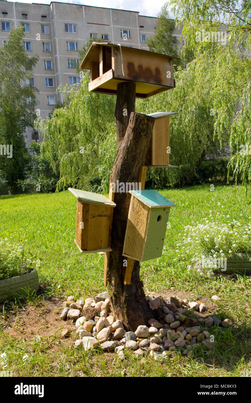 Birdhouses and a bird feeder in the garden in the courtyard of a ... Birdhouses and a bird feeder in the garden in the courtyard of a ...