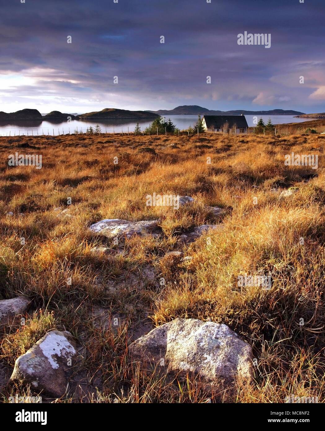 A winter view across the Wester Ross coast looking towards the Summer Isles as the sun sets. Stock Photo