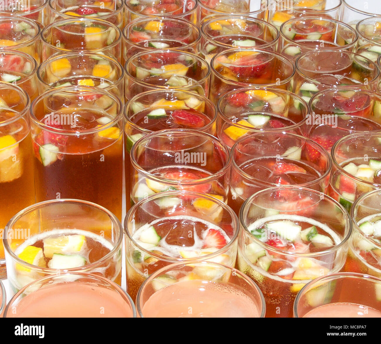 Pimms with summer fruit and ice in tall glass Stock Photo