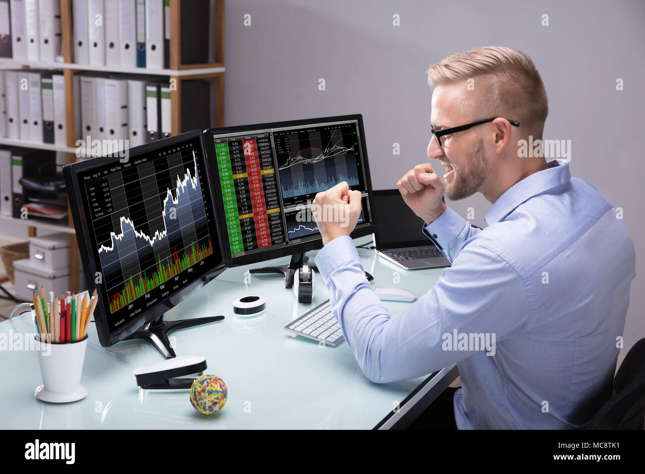 Excited Young Male Stock Market Broker Looking At Graph On Computer At Workplace Stock Photo Alamy Excited Young Male Stock Market Broker Looking At Graph On Computer At Workplace Stock Photo Alamy