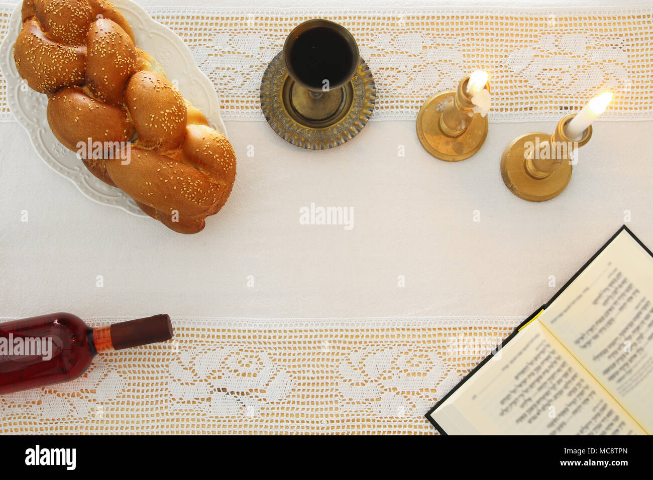 shabbat image. challah bread, shabbat wine and candles on the table. Top view Stock Photo