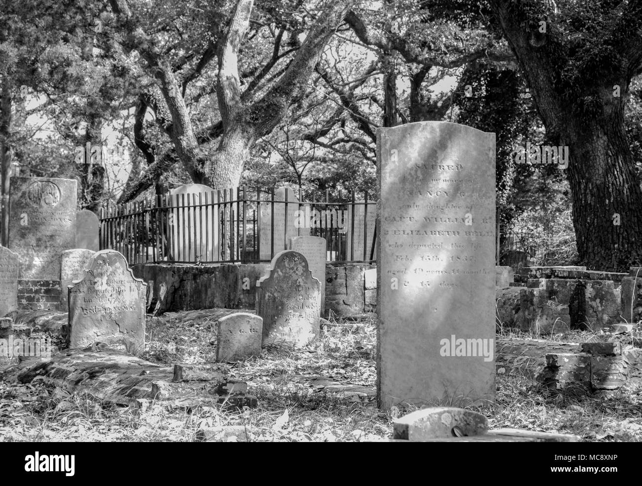 Headstones in the historic graveyard at Beaufort, North Carolina. Monochrome and color. Ghosts, goblins, and serenity all in one place! Stock Photo