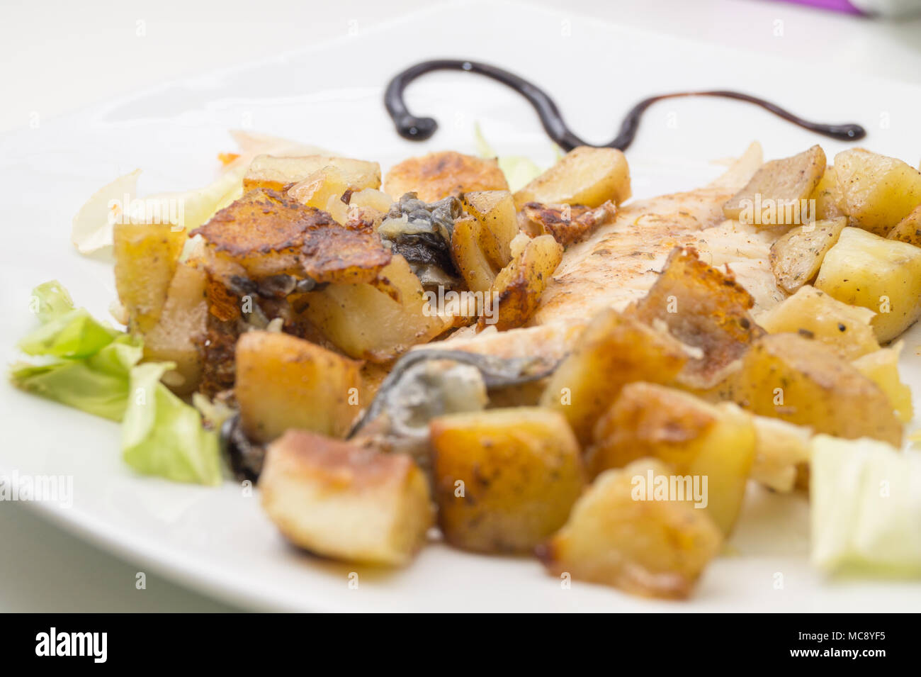 sea bass in the dish with potatoes and salad Stock Photo Alamy