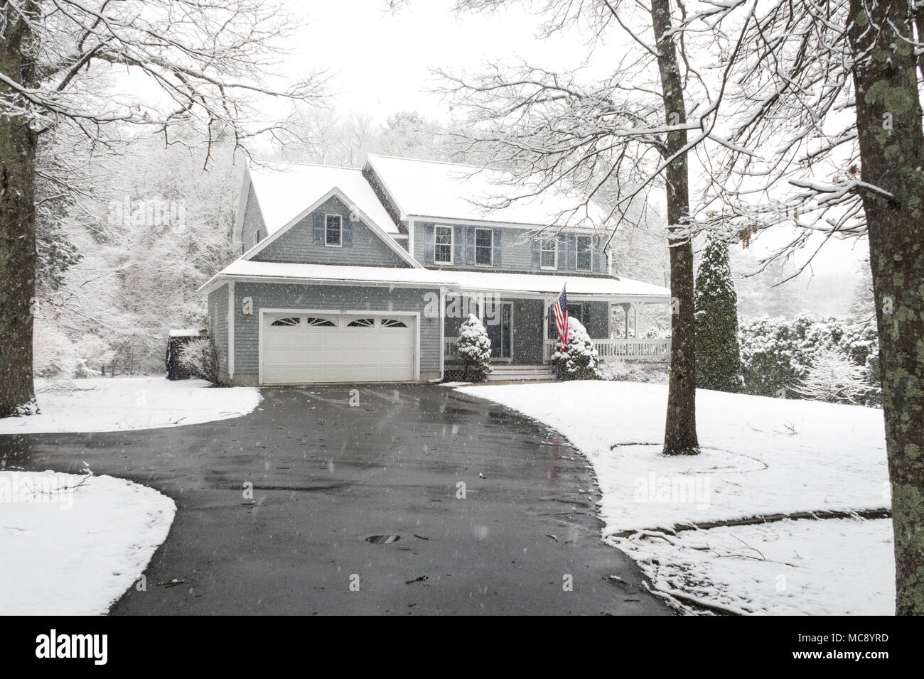 Luxury Suburban House in a Snowstorm, MA, USA Stock Photo