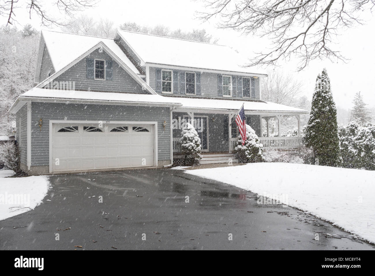 Luxury Suburban House in a Snowstorm, MA, USA Stock Photo