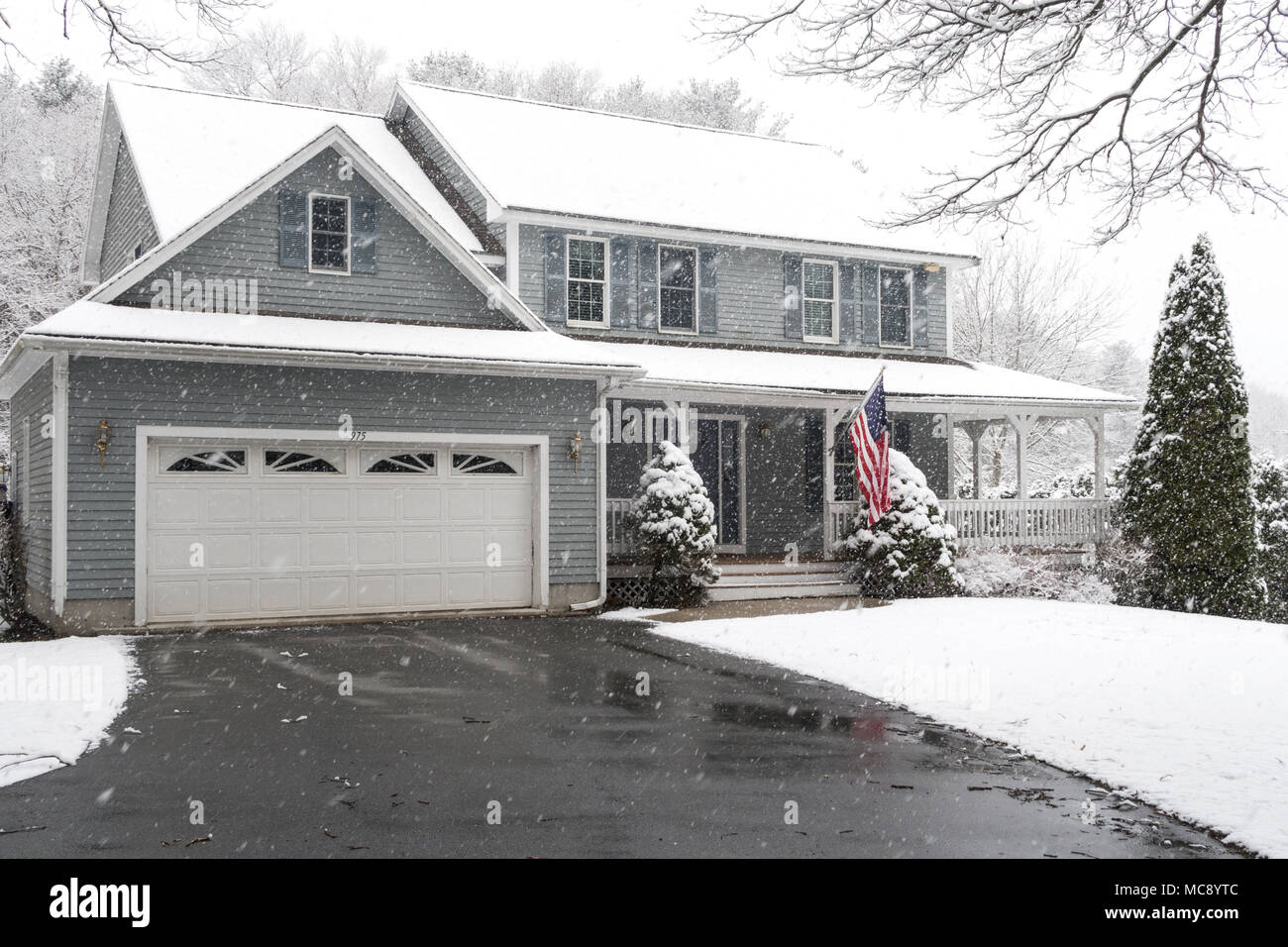 Luxury Suburban House in a Snowstorm, MA, USA Stock Photo