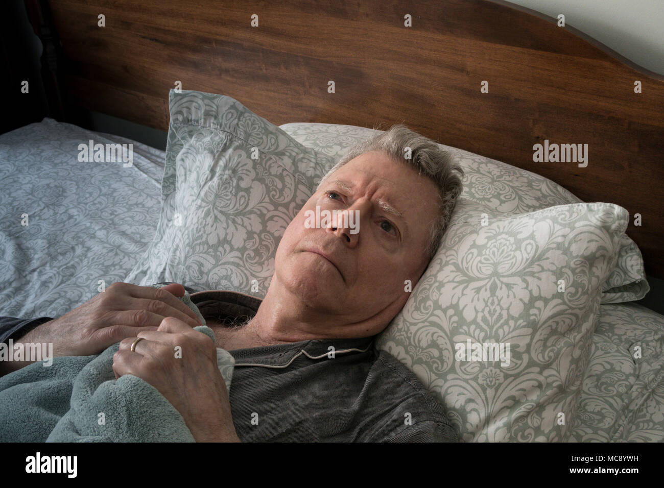 Senior Man Wide awake Worrying in Bed, USA Stock Photo