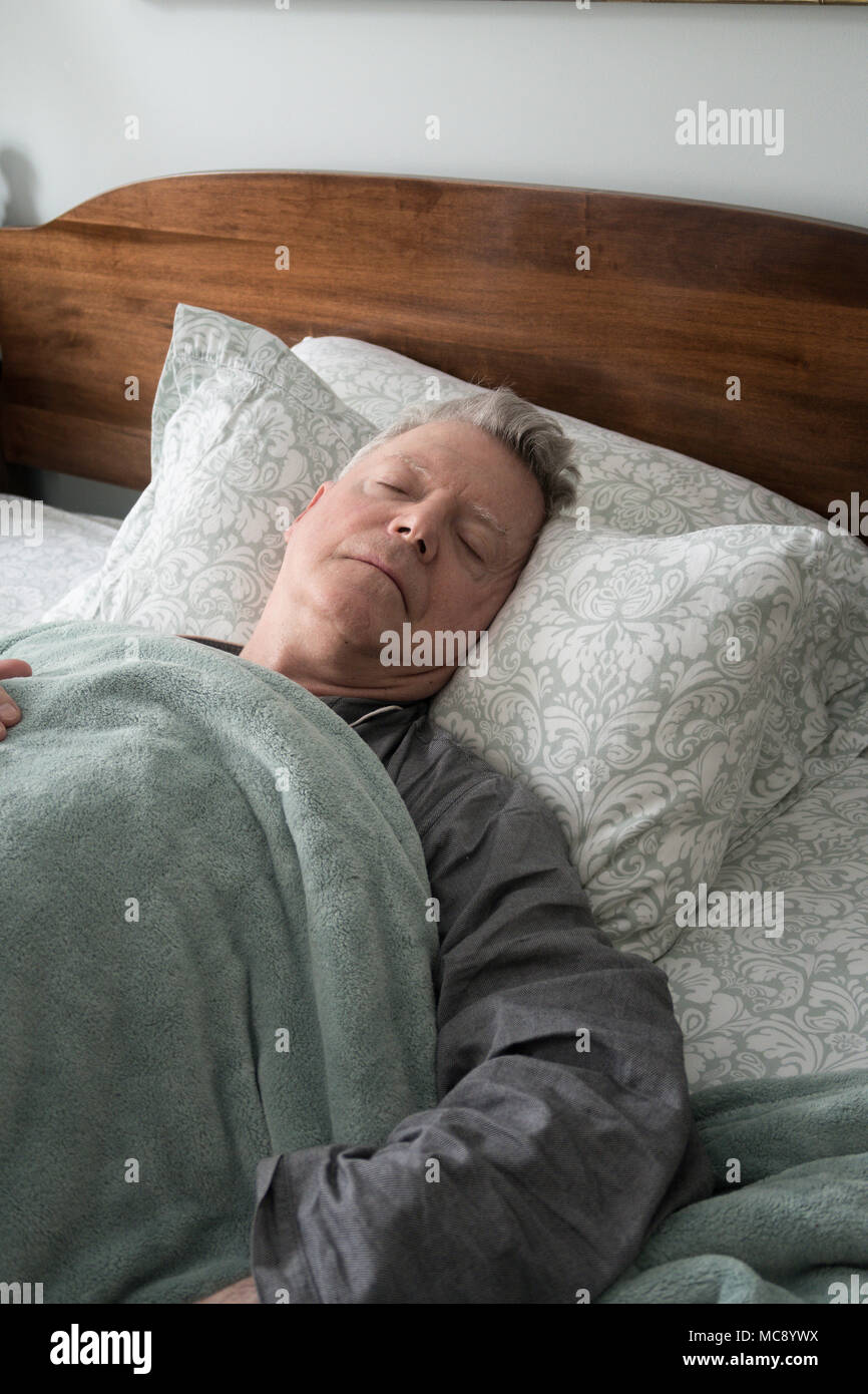 Senior Man in Bed Peacefully Sleeping, USA Stock Photo