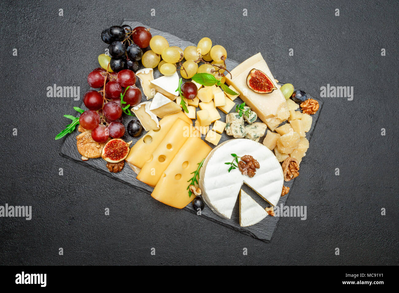 various types of cheese on stone serving board Stock Photo Alamy