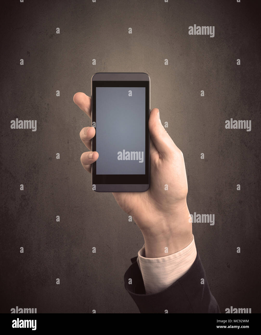 Caucasian hand in business suit holding a blank screen smartphone Stock ...