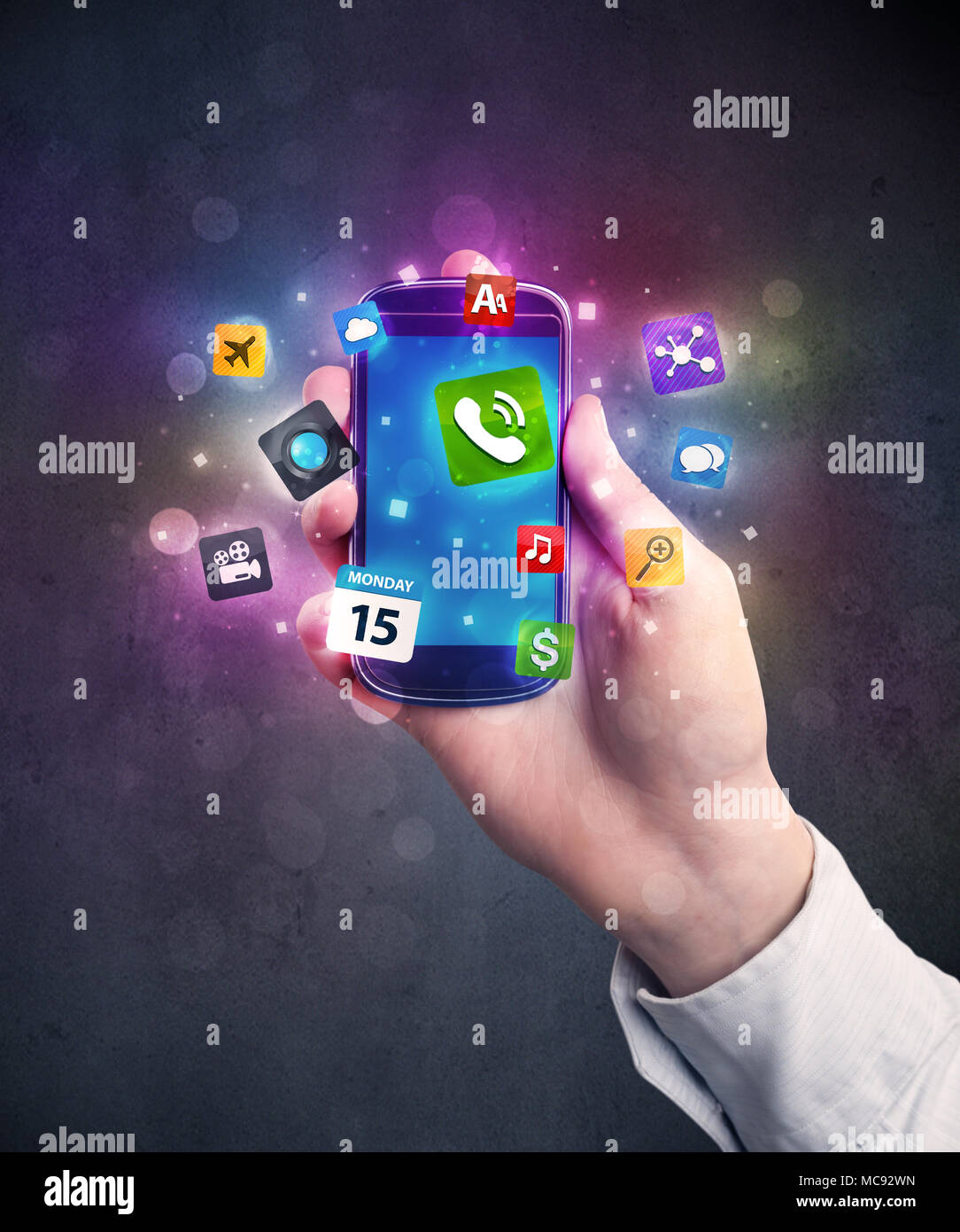 Caucasian hand in business suit holding a smartphone with colorful ...