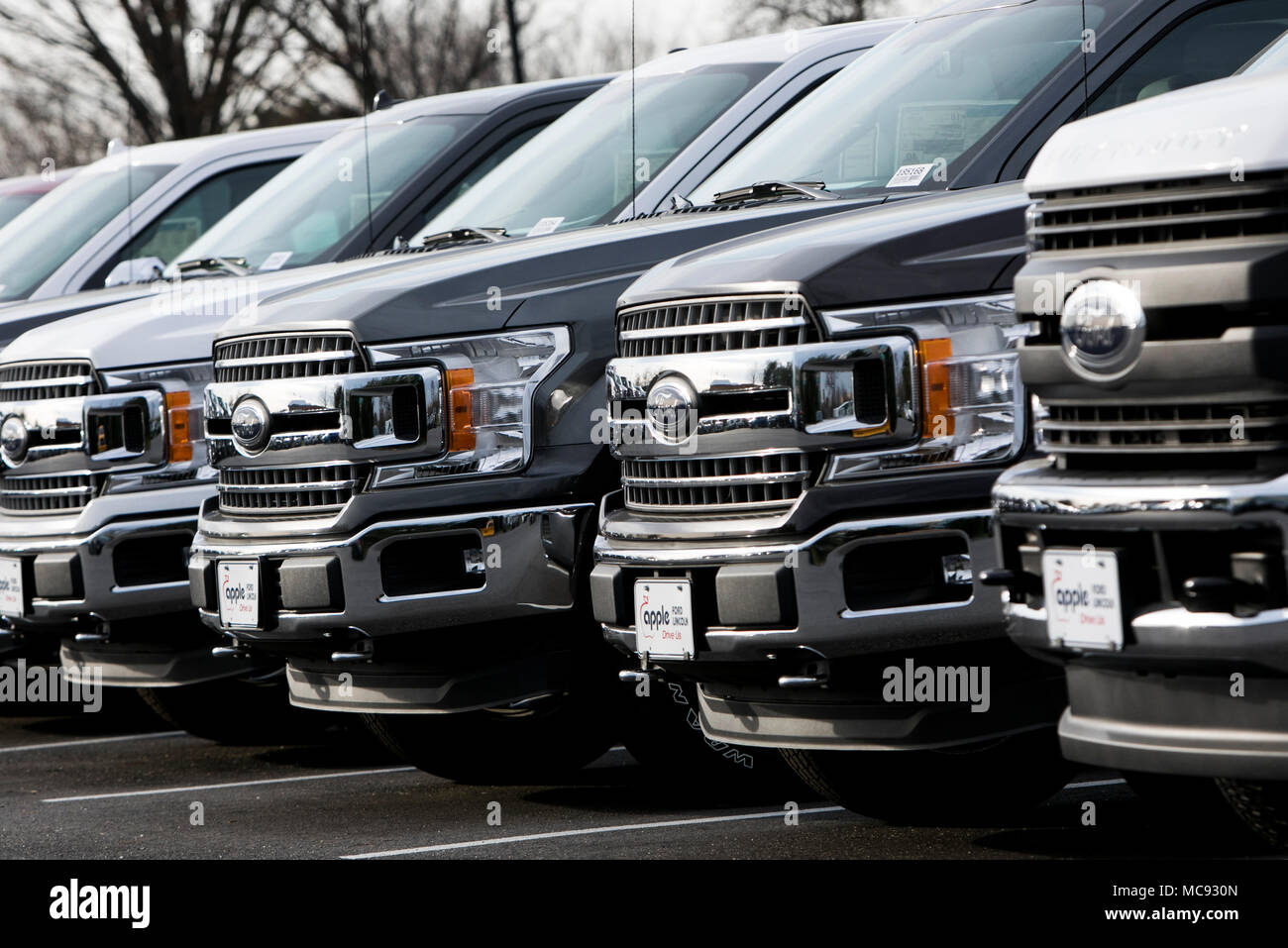 A row of new Ford F-series pick-up trucks at a car dealership in Columbia, Maryland on April 13, 2018. Stock Photo