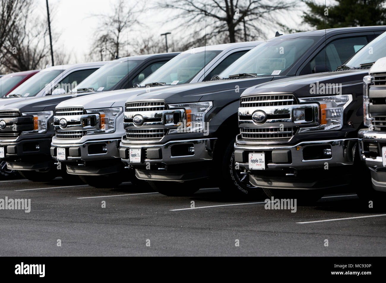 A row of new Ford F-series pick-up trucks at a car dealership in Columbia, Maryland on April 13, 2018. Stock Photo