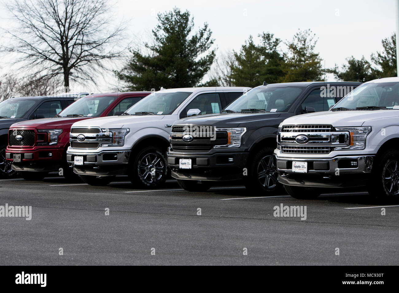 A row of new Ford F-series pick-up trucks at a car dealership in Columbia, Maryland on April 13, 2018. Stock Photo