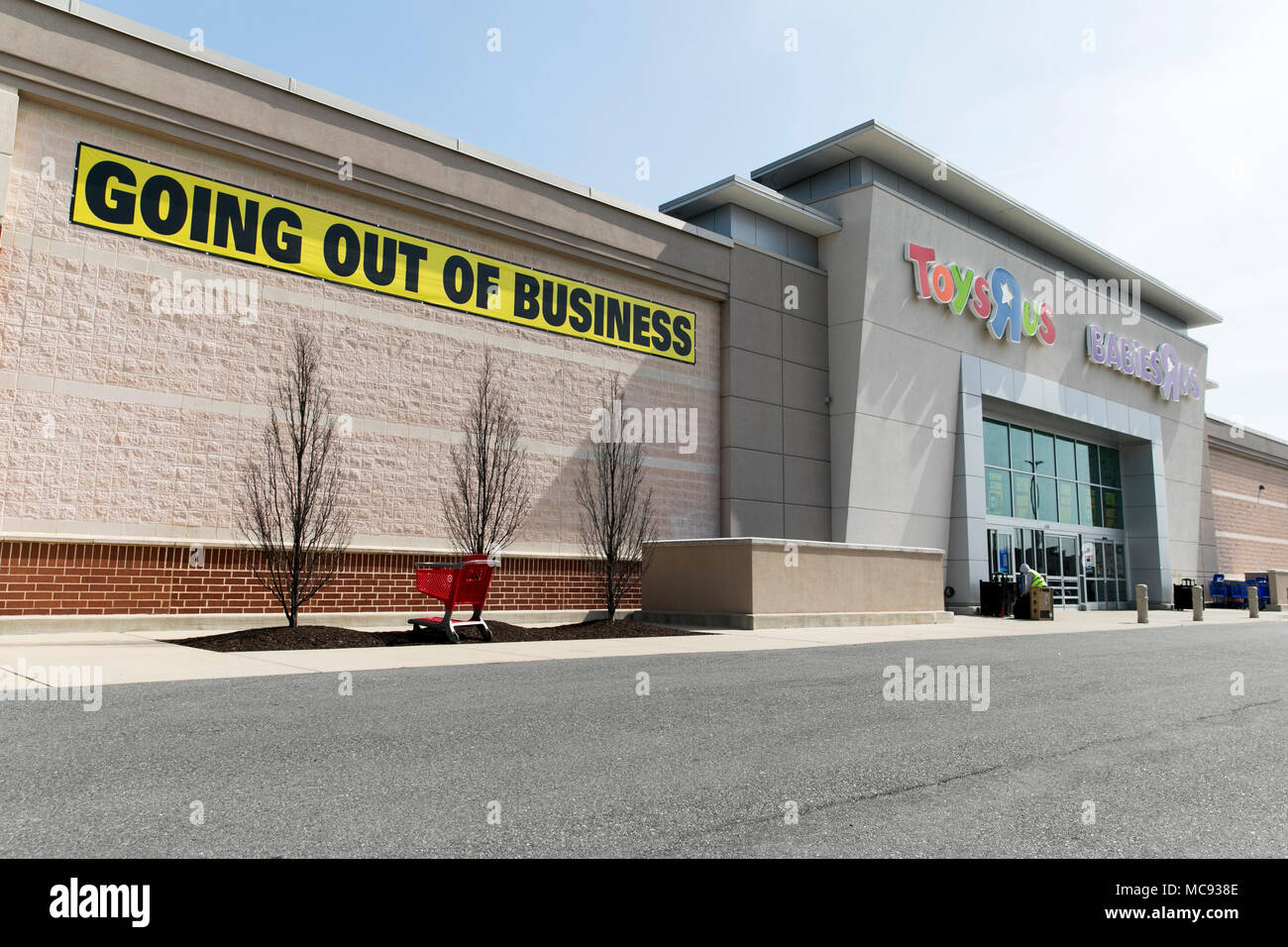 A logo sign outside of a joint Toys 'R' Us and Babies 'R' Us retail store in Columbia, Maryland with 'Going Out Of Business' signage on April 13, 2018 Stock Photo