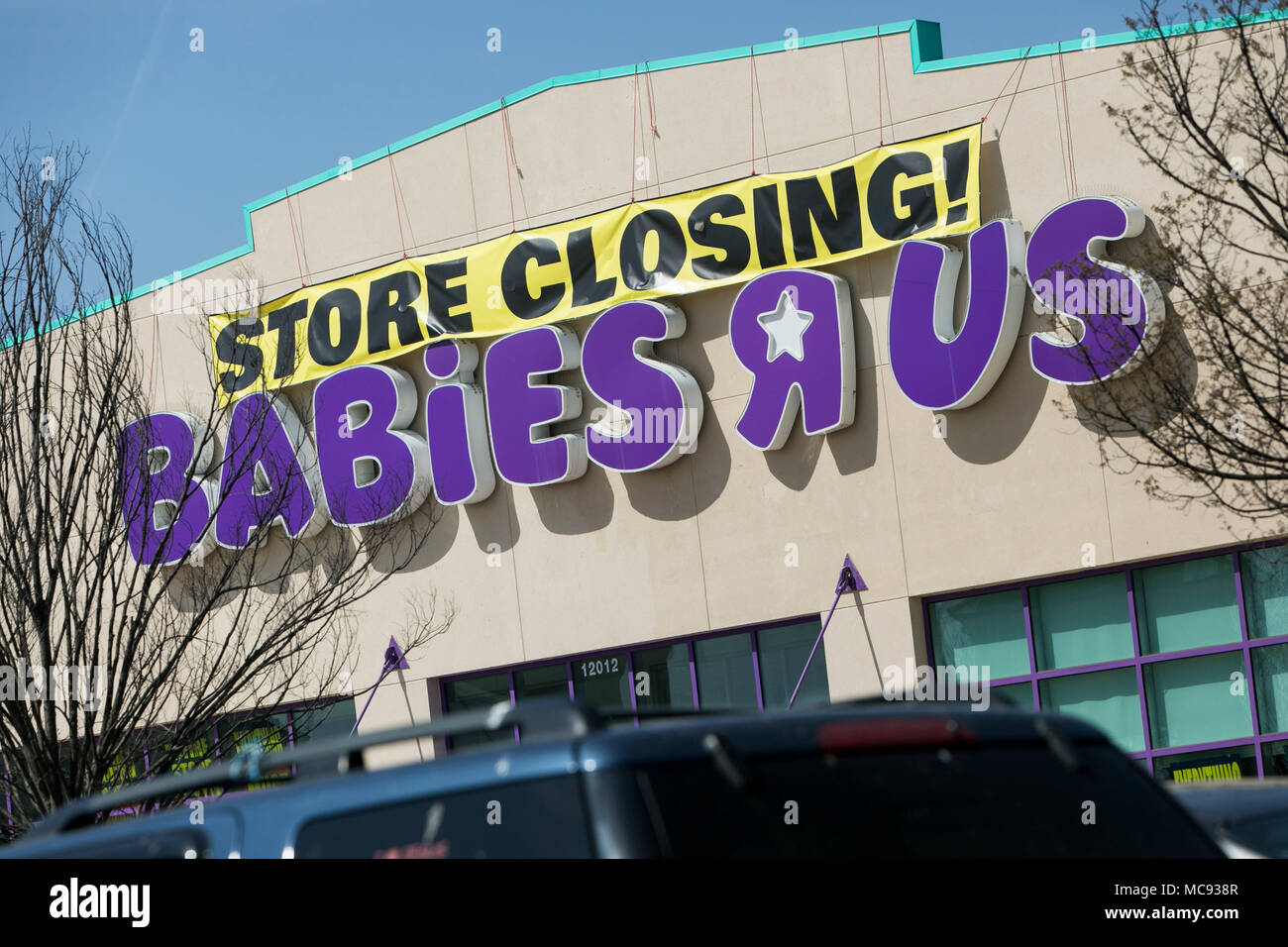 A logo sign outside of a Babies 'R' Us retail store in Silver Spring, Maryland with 'Store Closing' signage on April 13, 2018. Stock Photo