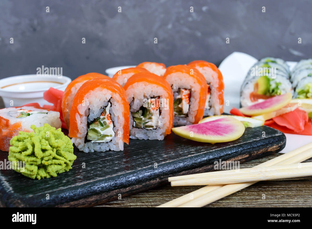 Various kinds of sushi served on wooden background. Sushi menu. Japanese food. Sushi set. Stock Photo