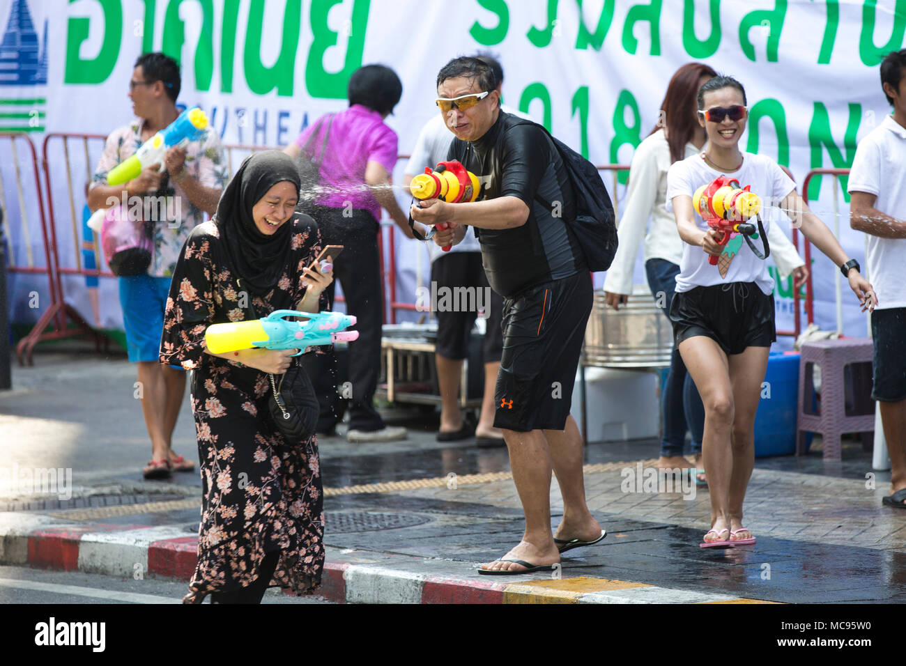 BANGKOK, THAILAND - APRIL 13, 2018: People on the streets of Bangkok during the first day of Songkran Festival, Thai New Year celebrations. Stock Photo