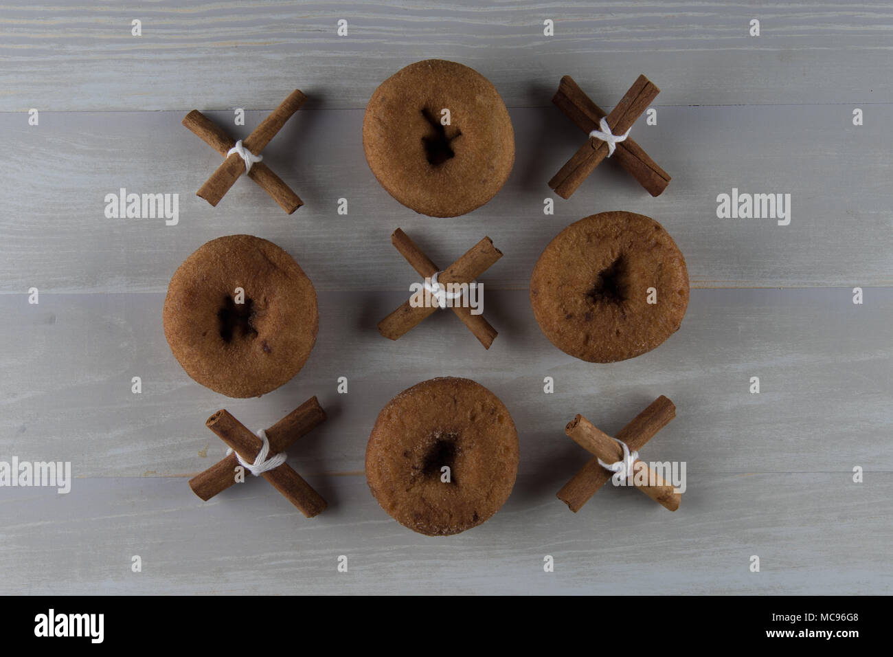 Three by three grid of cinnamon and donuts on light background stock