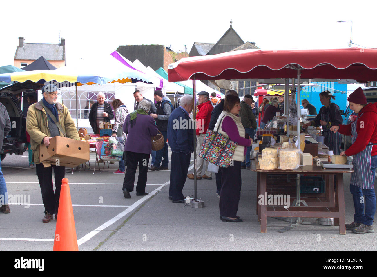 a weekly country food market full food stalls and full of people shopping and bargain hunting in skibbereen, ireland,a popular holiday town. Stock Photo