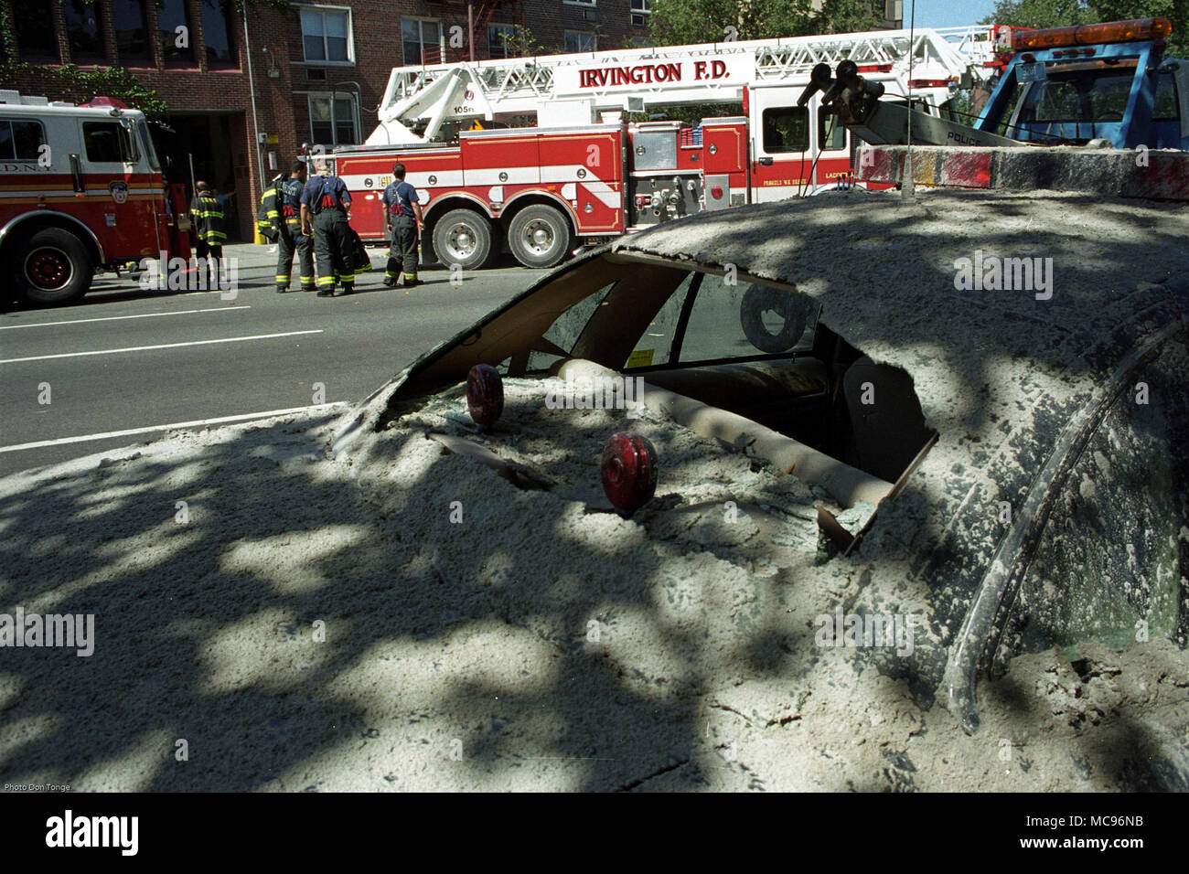 Abandoned damaged police car and The Irvington Fire Department NYC on duty at the terrorist attack on The World Trade Center New York City on 9/11   photo DON TONGE Photographer Stock Photo