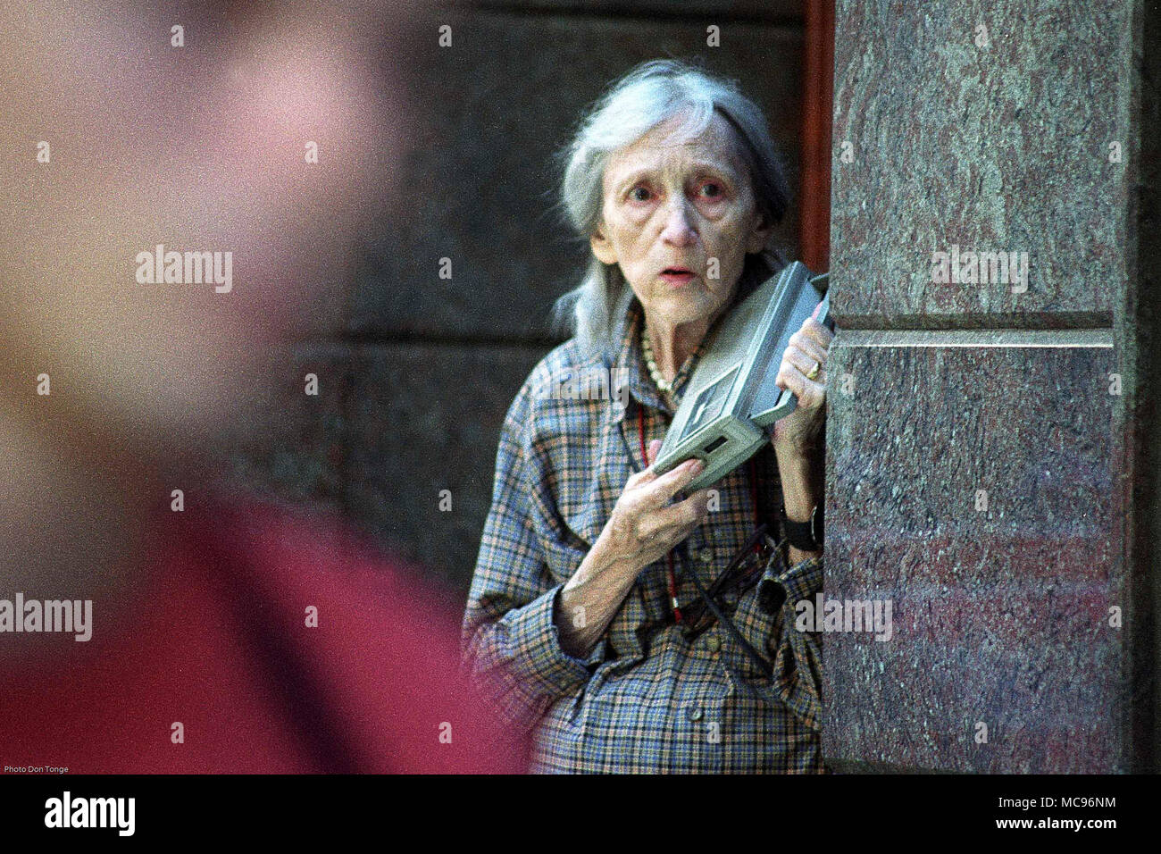 Elderly female in shock and disbelief while listening to news updates on her radio a few hours after the terrorist attack on The World Trade Center New York City on 9/11   photo DON TONGE Photographer Stock Photo