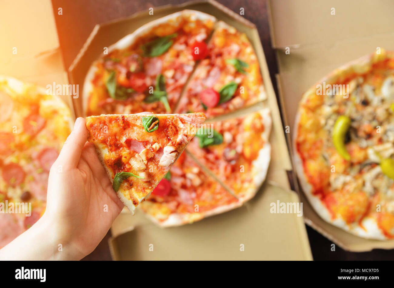 Female Hand Taking Slice Of Fresh Pizza From Delivery Box Top View Dark Background Junk Food Sunny Morning With Sunlight Toned Pastel Color Stock Photo Alamy