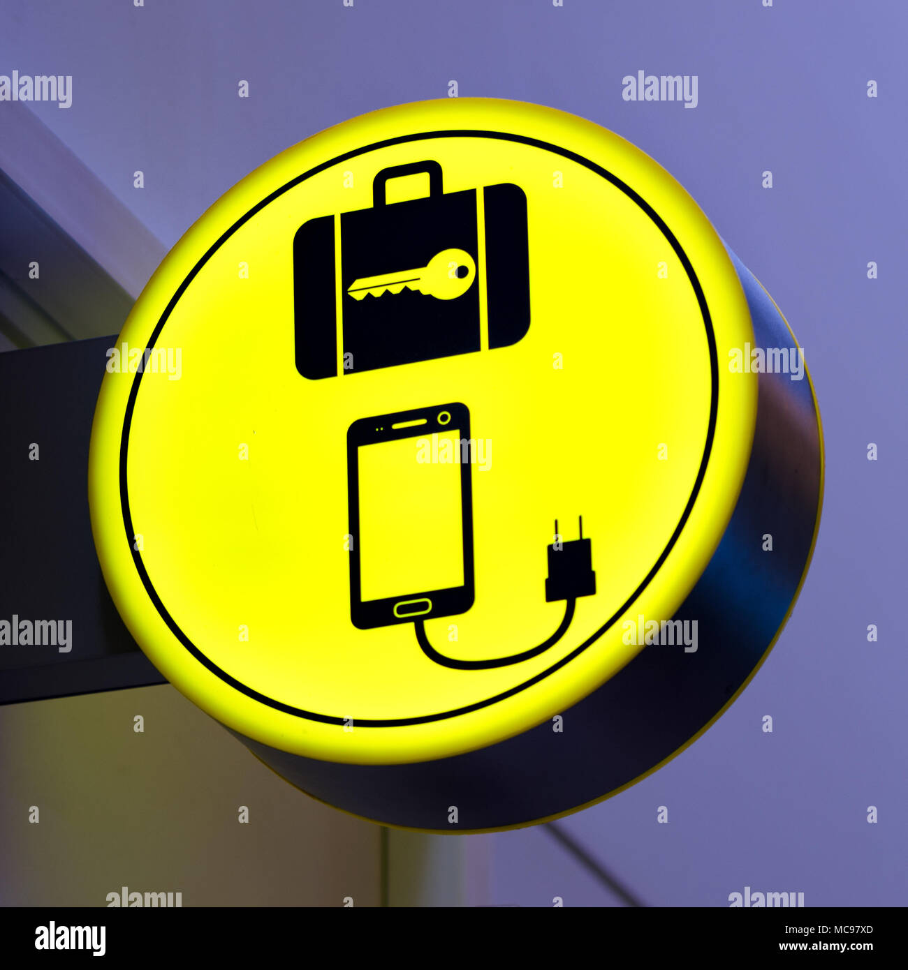 Charging mobile, cellphone battery icon in public area, airport. Locker luggage sign. Copy space Stock Photo