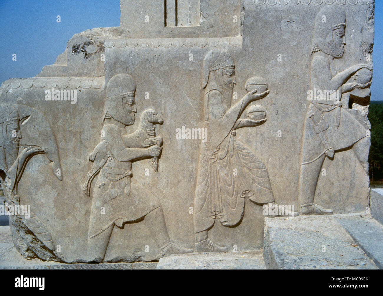 Achaemenid Empire. Persepolis. Apadana, The Audience Hall of Darius. Delivery of tributes to the Persian king by the Cilicians (vassal nation), 5th century BC. Slaves carrying gifts. Islamic Republic of Iran. Stock Photo