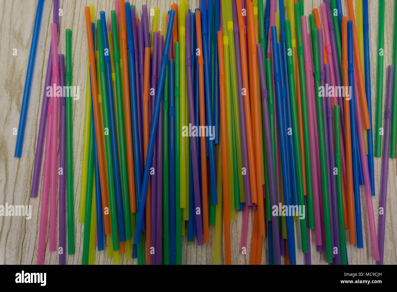 Colored plastic drinking straws on a white background Stock Photo