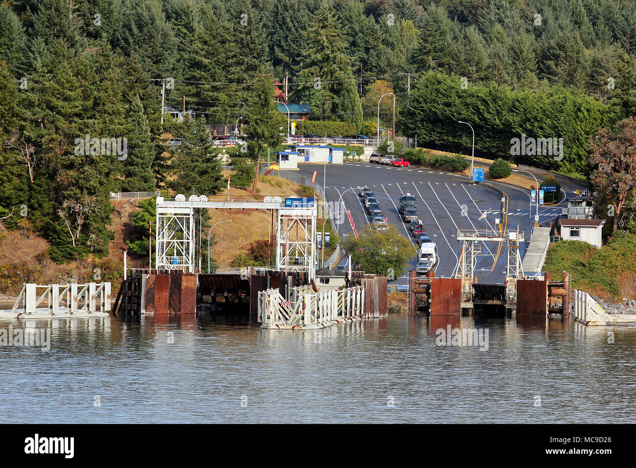 Cars waiting at the ferry terminal on Mayne Island, in the Canadian Gulf Islands on British Columbia's Pacific Coast Stock Photo