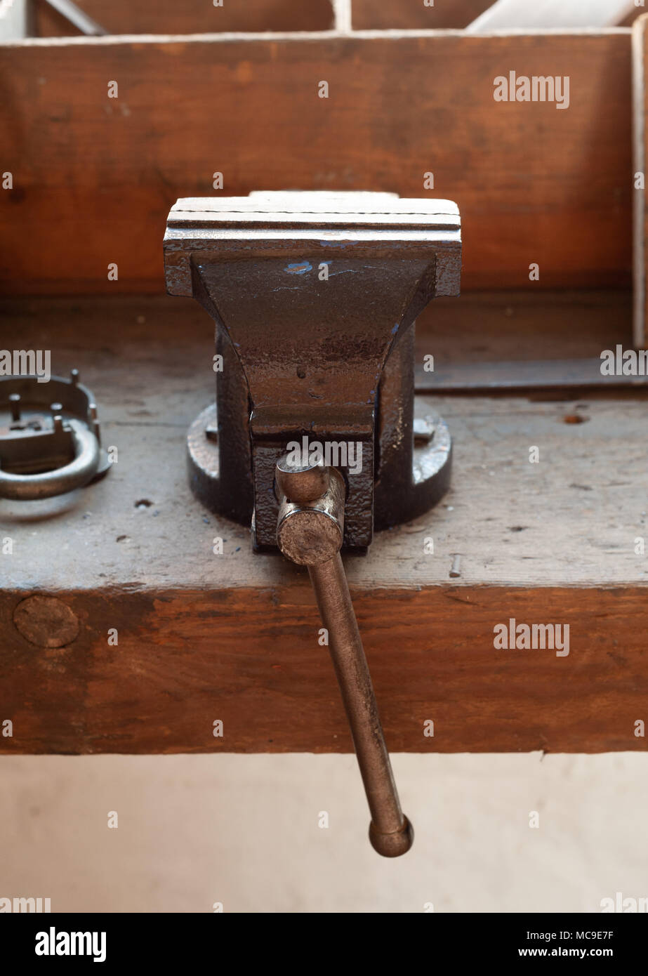 Antique Vice on workbench in lock makers workshop Stock Photo
