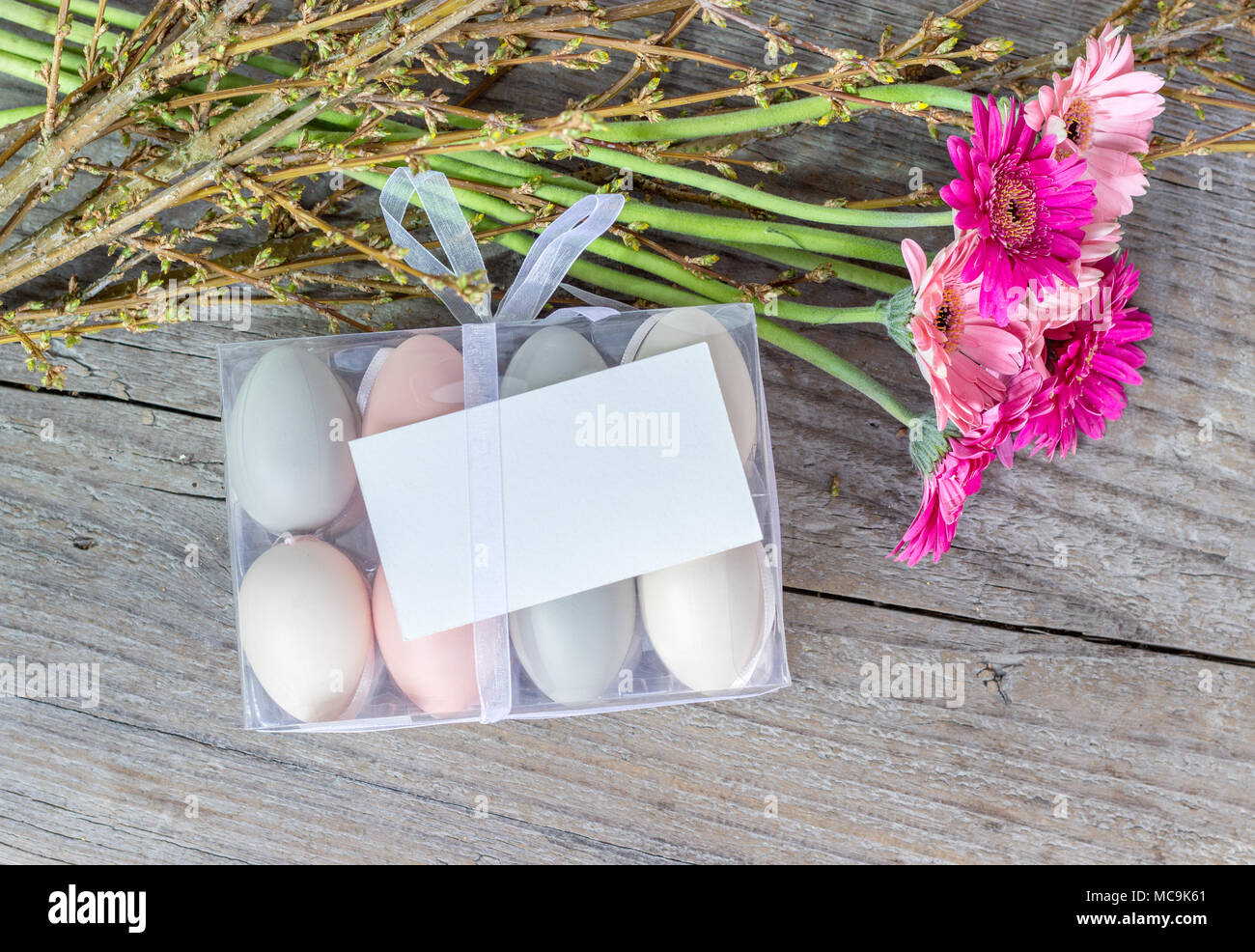 Easter eggs with pink gerbera and white copy space Stock Photo