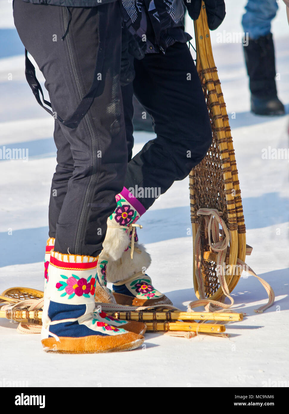 Traditional moccasins and snowshoes (northern footwear) at the Muskrat Jamboree (held every March) in Inuvik, Northwest Territories, Canada. Stock Photo