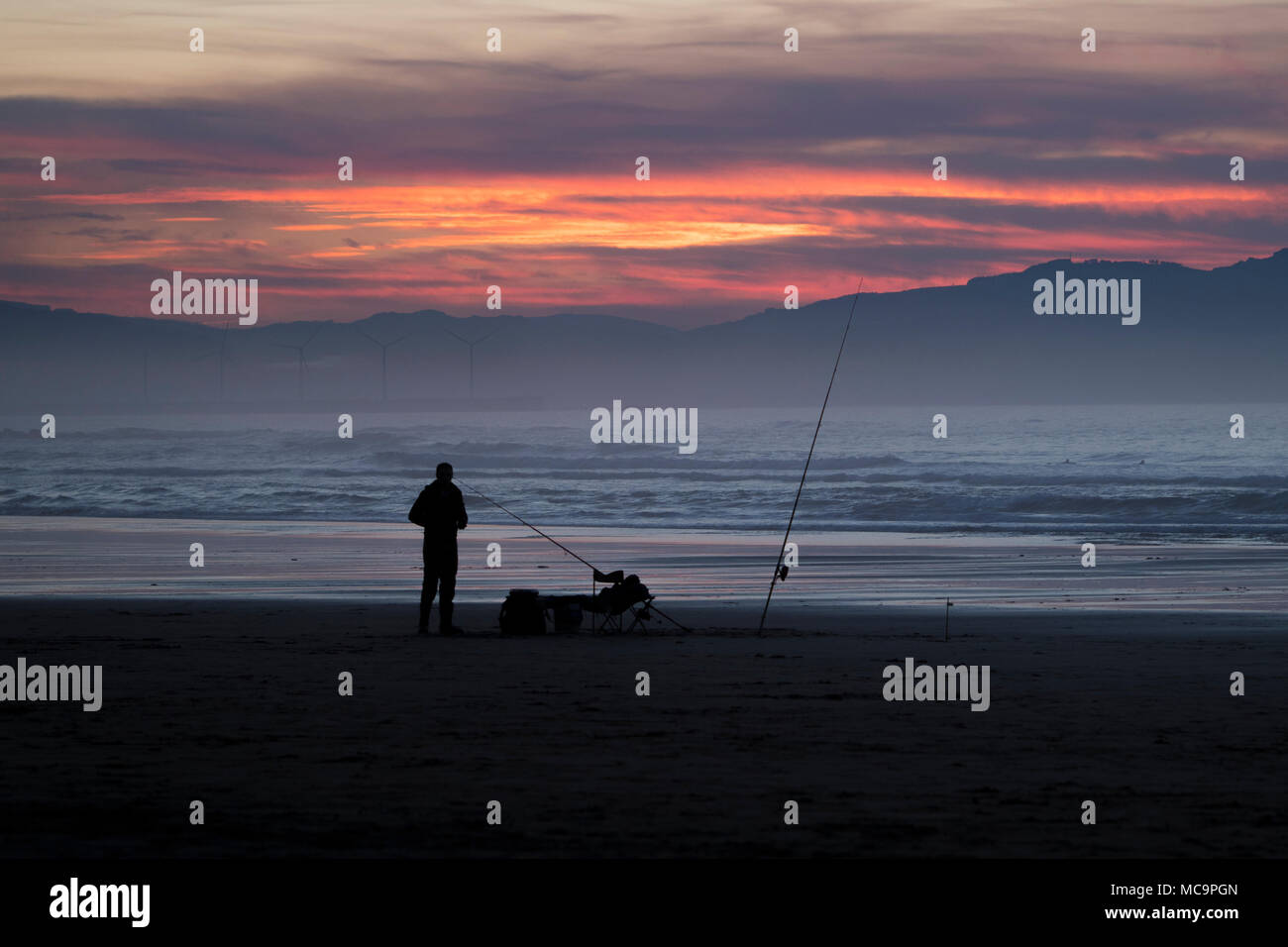 silhouettes on the beach at sunset Stock Photo - Alamy