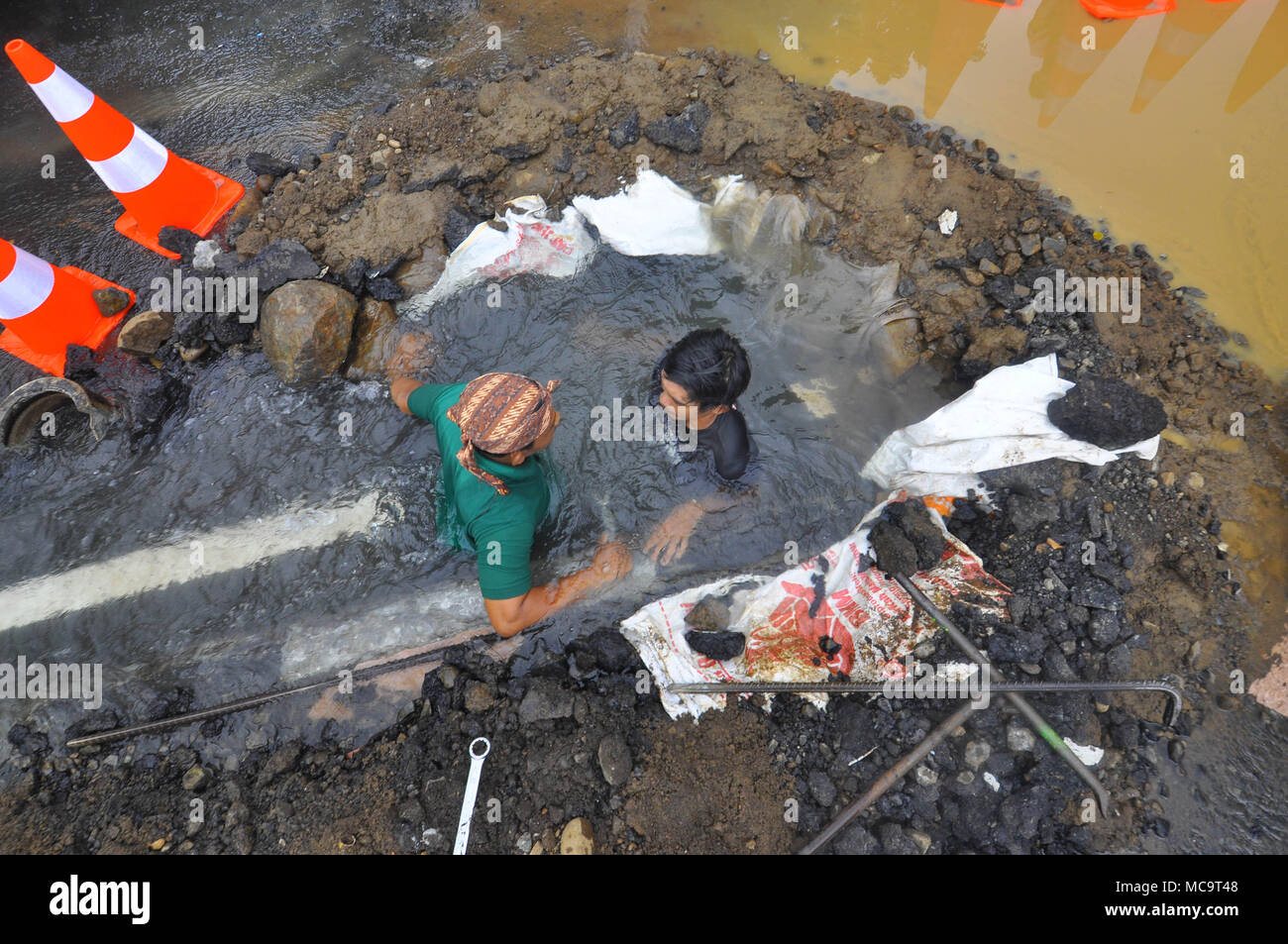 Bogor, Indonesia. 14th Apr, 2018. The water leak from pipe on jalan  Harupat, Sempur, Bogor made some operators from Local Water Supply Utility  busy. Because the leak was near Bogor Presidential Palace